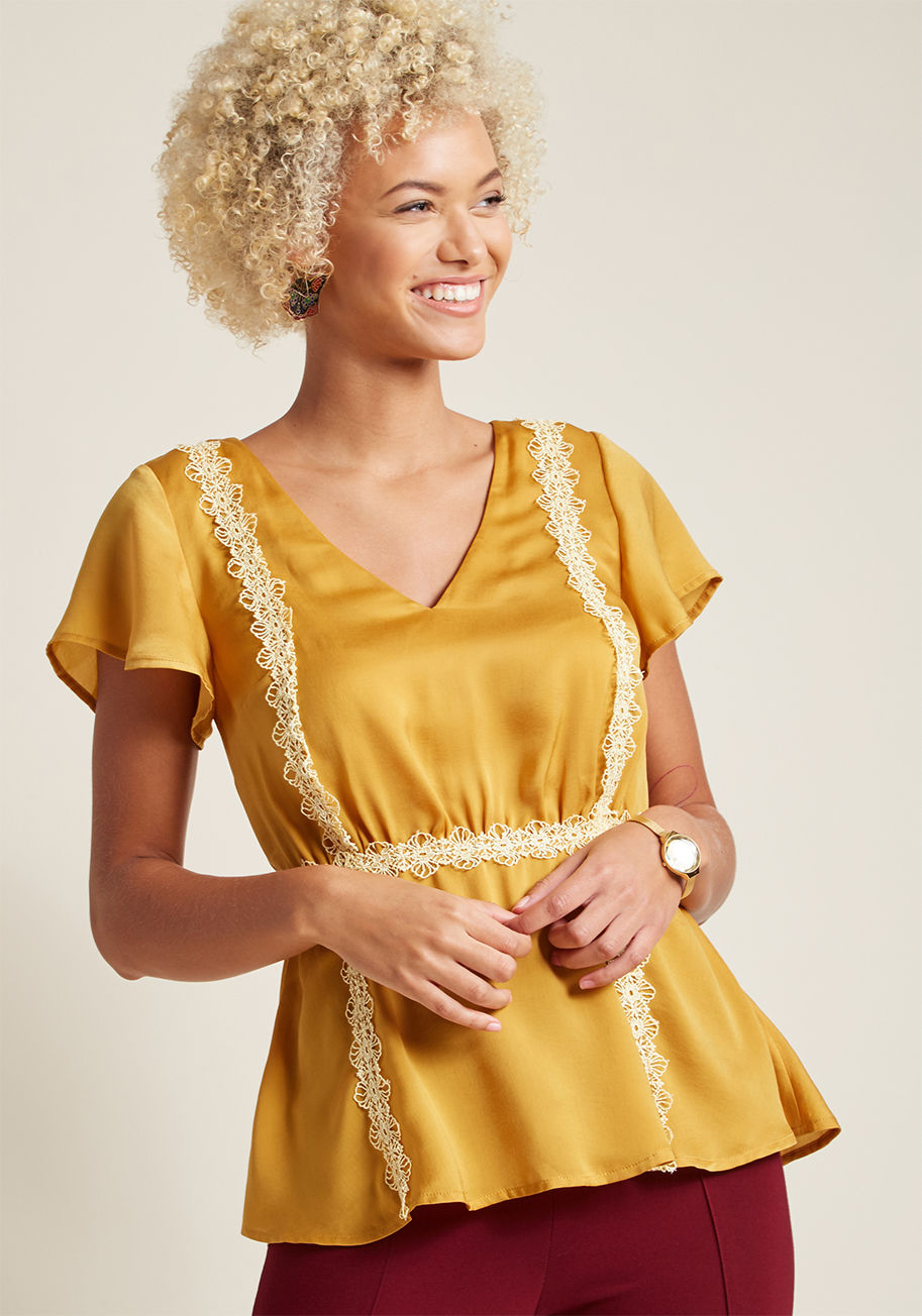 Mct1475 - Wear it to work or to wow on the weekend - this rich yellow blouse is prepared to impress! Part of our ModCloth namesake label, this satiny V-neck top turns to fluttering short sleeves, a peplum hemline, and ornate ivory appliques acting as contouring tri