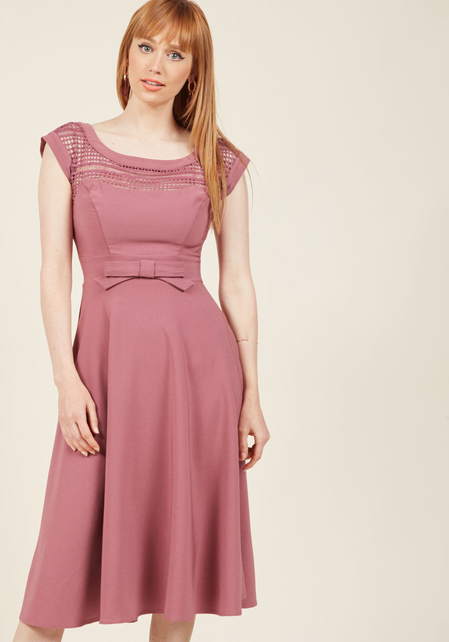 MDD1142 - If you're going to give your most coquettish expression, you might as well lend it as an accessory to this muted berry dress! Made stunning from a bateau neckline detailed with geometric lace, a waistline bow, and a swingy midi skirt touched with stretch,