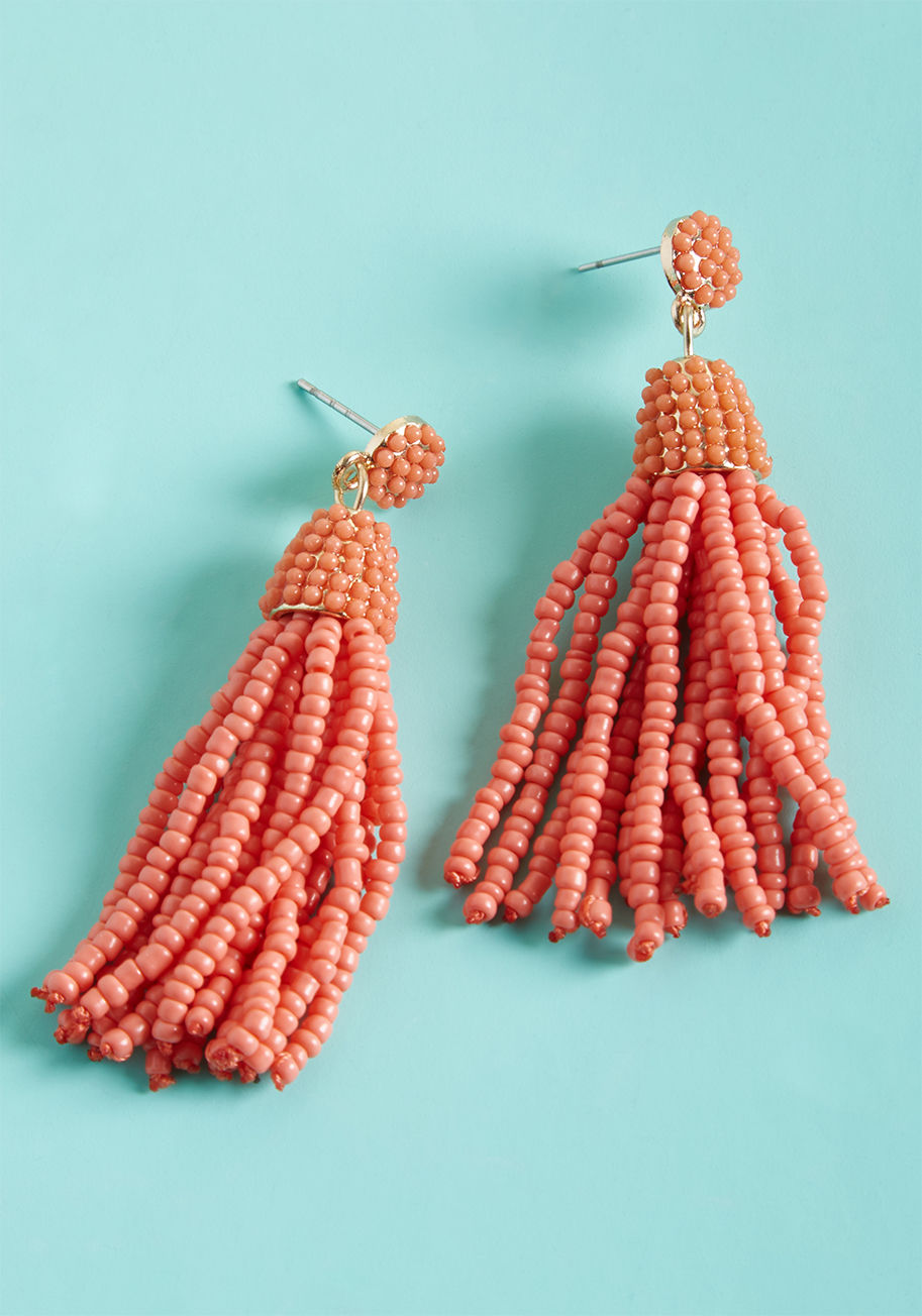 Spiff up with stylish spontaneity using these tassel earrings! Poppy red beads cover the round posts and dangly charms of this golden pair, adding fabulousness and festiveness to your fashionable look. by MER1090GDCO