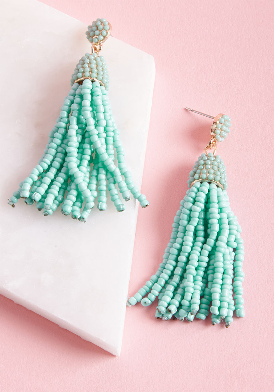 Spiff up with stylish spontaneity using these tassel earrings! Bright turquoise beads cover the round posts and dangly charms of this golden pair, adding fabulousness and festiveness to your fashionable look. by MER1090GDMNT