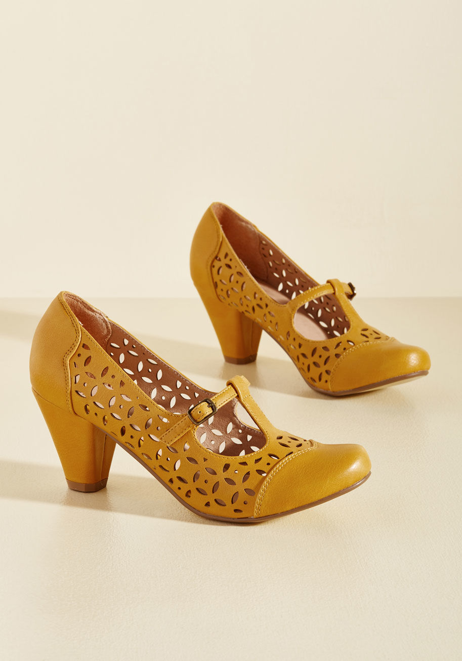 Milan - When deciding on these goldenrod pumps for the day's look, you don't just choose the sassy T-straps, collection of cutouts, and tapered, mid-height heels of this pair from Chelsea Crew - you also appoint an air of alluring, vintage-inspired flair to where
