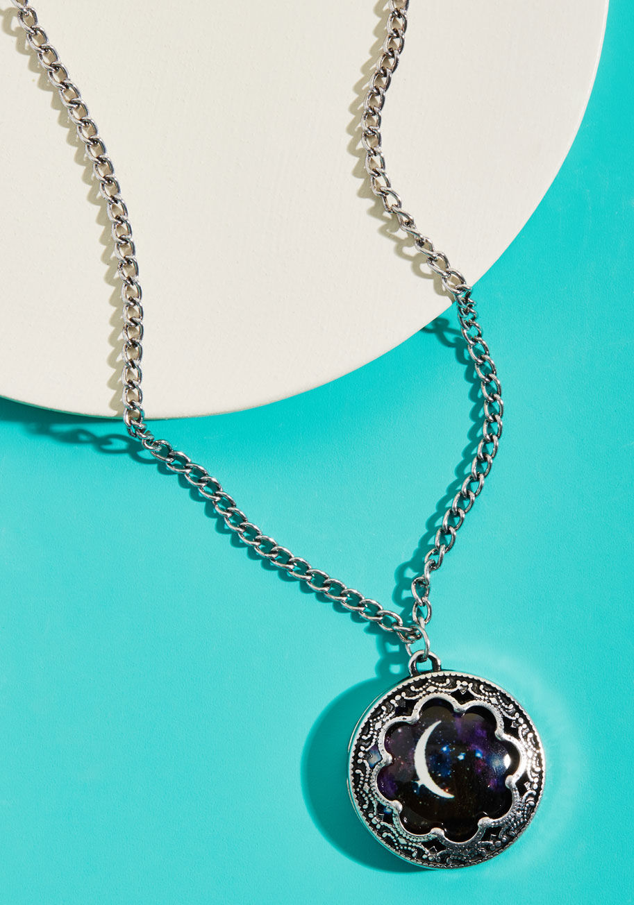 Now you can indulge your night owl side during daylight hours by sporting this silver pendant necklace! Inside the precious charm of this pretty piece is a slice of the night sky surrounding a crisp crescent moon, making celestial style a 'round-the-clock by N5213SV