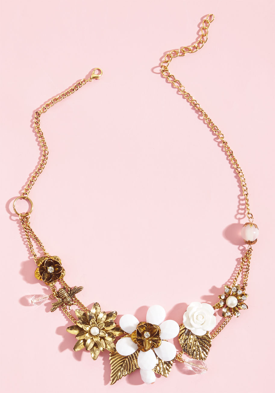 Harness the energy of your inner elegance by clasping this gold statement around your necklace, and seeing where its fine design takes you! Rhinestones, faceted beads, faux pearls, white-detailed flowers, and a single bee accent contribute to the inspirin by NA66969