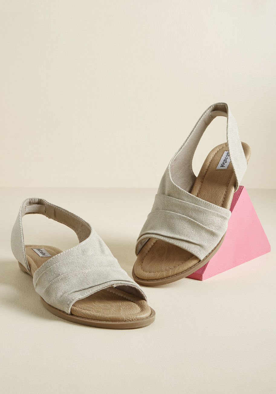 Finding supporters for these neutral slingback sandals is a simple task, indeed! Pleated uppers, a gold sparkles, and micro wedges all do their part by Shanti