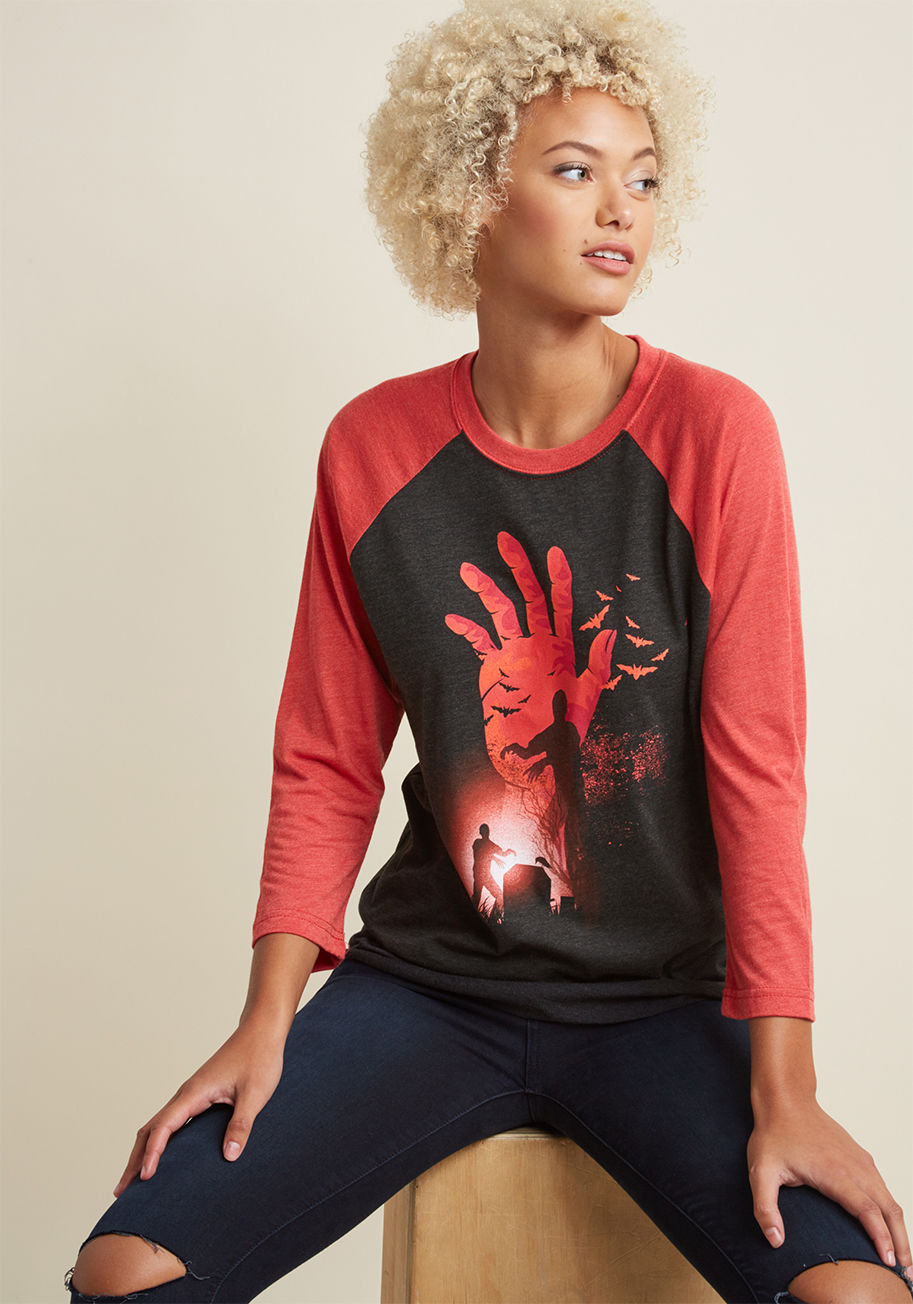 tbd2 - Don't groan and shamble to find the perfect tee for the spooky season - instead, perk up with this graphic tee! The 3/4-length sleeves and undead screen print of this heathered, black-and-red baseball tee are just what you need, so make it yours, sit back