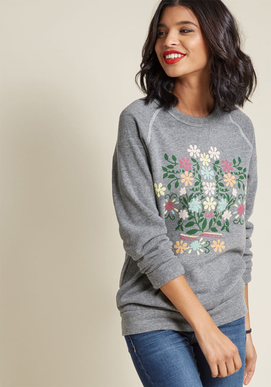 For every enthusiastic greeting you put out into the atmosphere while sporting this grey sweatshirt, you're sure to receive matching respects! A lovely bouquet graphic by The Olga