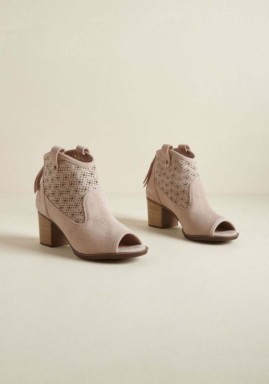 Trixi - Between their soft pink hue, peep toes, and stacked heels, these suede booties were designed to grab attention - and boy, do they ever! Taking a Western-inspired silhouette and giving it a modern, feminine twist with the addition of perforated shafts and 